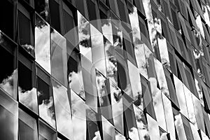 Reflections of cloudy sky on a glass facade