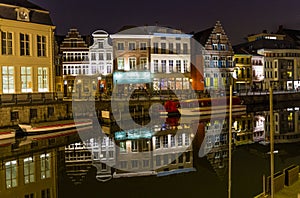 Reflections of colorful buildings in a canal in Ghent