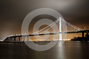 Reflections of fog and water on the Bay Bridge eastern span on a summer night.