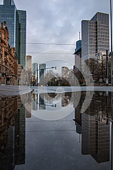 Reflections in Frankfurt am Main. Great reflection in puddles. The city, skyscrapers and streets are reflected in the water