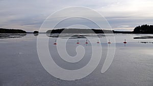 Reflections of frozen buoy in Runn lake near Falun in Sweden