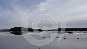 Reflections of frozen buoy in Runn lake near Falun in Sweden