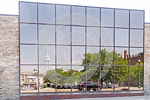 Reflections on glass side of building of city hall and downtown area Schenectady New York