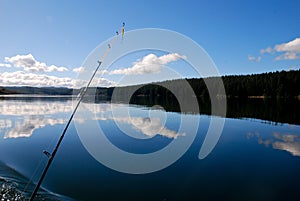 Reflections with lone fishing rod on Lake Maraetai, Mangakino, Taupo New Zealand Aotearoa
