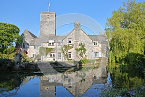 Reflections of Mill Pond cottages and St Mary`s Church in Church Hill, Swanage