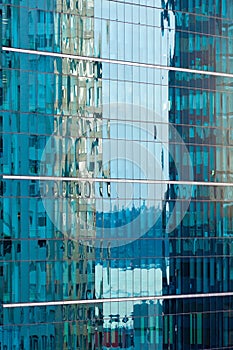 Reflections in modern glass-walled building facade