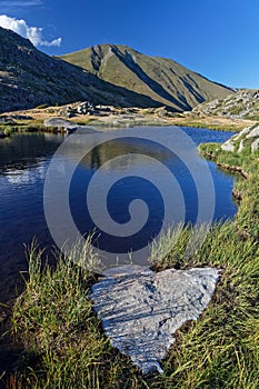 Reflections on a mountain lake of French Alps