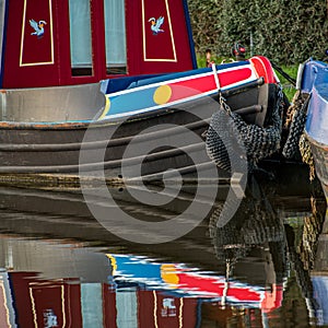 Reflections of a narrowboat in canal