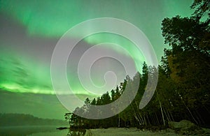 Reflections of northern lights in Swedish lake