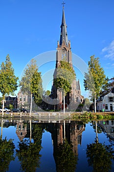 Reflections of the Roman Catholic Saint Lawrence Laurentius church, located along herengracht street in Weesp, North Holland