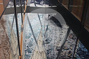 Reflections of the sea through the promenade deck of the cruise ship Iona