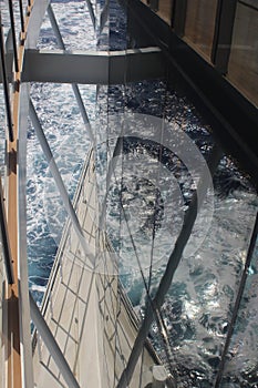 Reflections of the sea through the promenade deck of the cruise ship Iona