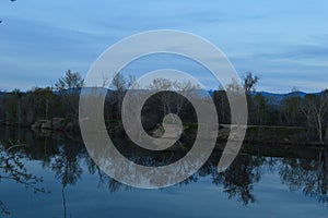 Reflections of shore on lake on a blue day!