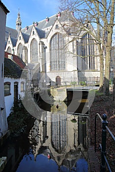 Reflections of Sint Janskerk church on a canal, Gouda, South_Holland, Netherlands