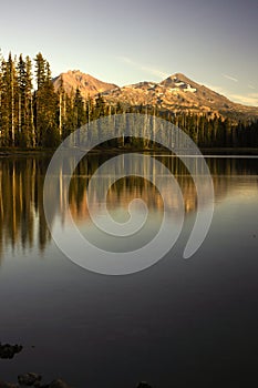 Reflections of the Sisters mountains at Scott lake during the fall of 2022