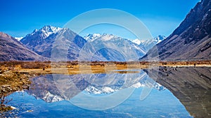 Reflections of Snow mountains in the lake in Leh