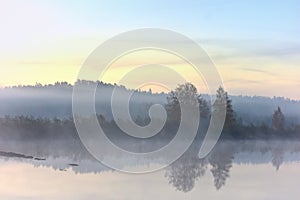 Reflections of sunrise at quiet lake in The Lithuania