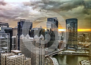 Reflections of sunset and Chicago cityscape on the reflective buildings and river.