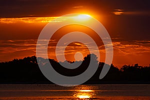 reflections of sunset rays in water