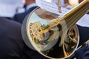 Reflections in the trombone bell of the adjacent buildings during the Alcoy festivities photo