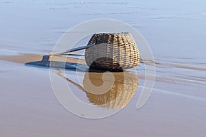 Reflections of vintage fishing creel on  water in Marau, Brazil