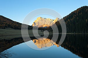 Reflections on water, autumn panorama from mountain lake