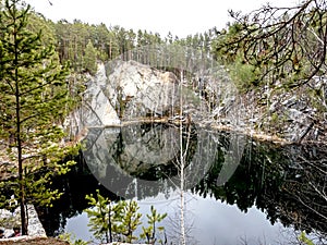 Reflections in the water of a flooded quarry called Talkov stone near the city of Yekaterinburg photo