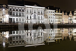 Reflections of white buildings in a canal in Ghent