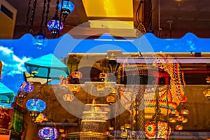 Reflections in a window in downtown Santa Fe showing a very blue sky and Turkish lanterns and adobe architecture