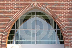 Reflective arched glass window of a church