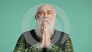 Reflective Elder Posing with Prayer Hands, Seeking Solace and Peace