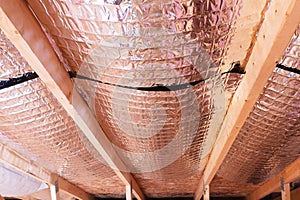 Reflective Radiant Heat Barriers Between Attic Joists Used as Ba photo