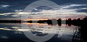 Reflective sunset on a prairie lake