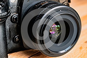 Reflex camera or dslr with reflexion on lens, photograph equipment, for professionnal and agency