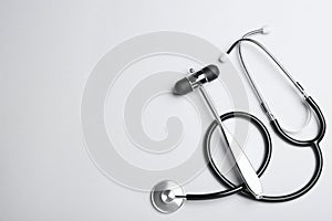 Reflex hammer with stethoscope on white background, flat lay and space for text. Nervous system diagnostic