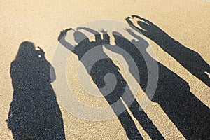 Reflex shadow friendship on sand