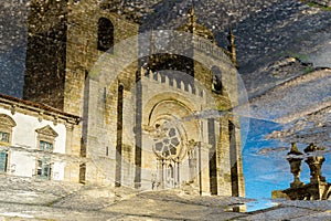 Reflexion of the catholic church in puddle