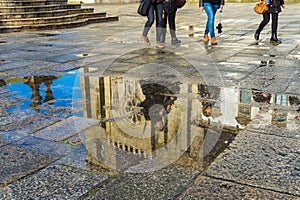 Reflexion of the catholic church in puddle