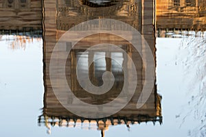 Reflexion of house in water with blue background