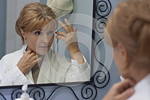 Reflexion of woman looking in mirror photo