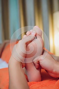Reflexology foot massage, spa foot treatment close-up.