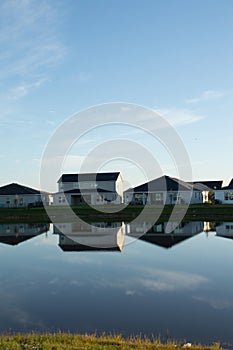 Reflection of new housing unit, in a tropical lake location