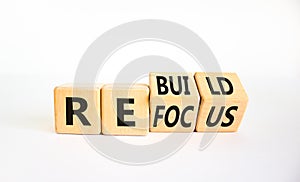 Refocus and rebuild symbol. Turned cubes and changed the word `refocus` to `rebuild`. Beautiful white table, white background.