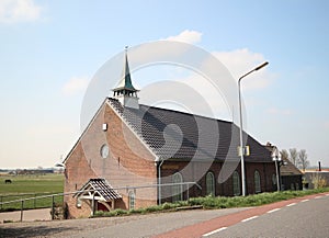 Reformed small church in the sun in Den Bommel on island Goeree Overflakkee in the Netherlands.