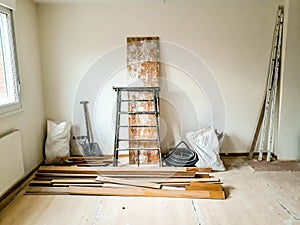 Reforms of interior in room with white wall and elements of construction