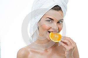 Refreshed woman eating orange