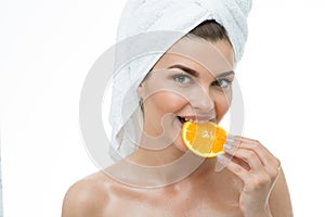 Refreshed woman eating orange photo