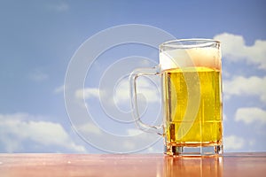 Refreshing beer mug on sky background