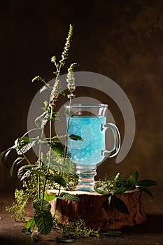 Refreshing blue drink with baslic grains and blooming fresh mint