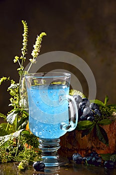 Refreshing blue drink with baslic grains and blooming fresh mint